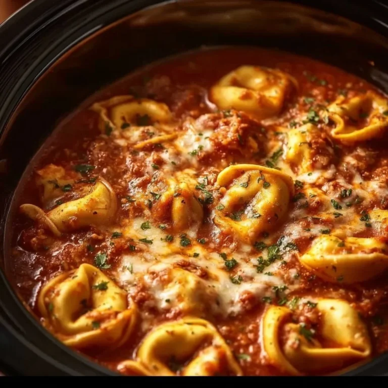 Slow Cooker Cheesy Tortellini in a bowl with melted cheese and herbs