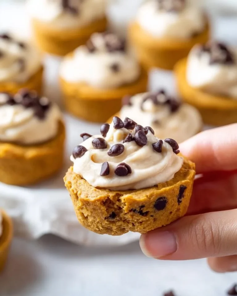 Freshly baked pumpkin chocolate chip cookies on a cooling rack.